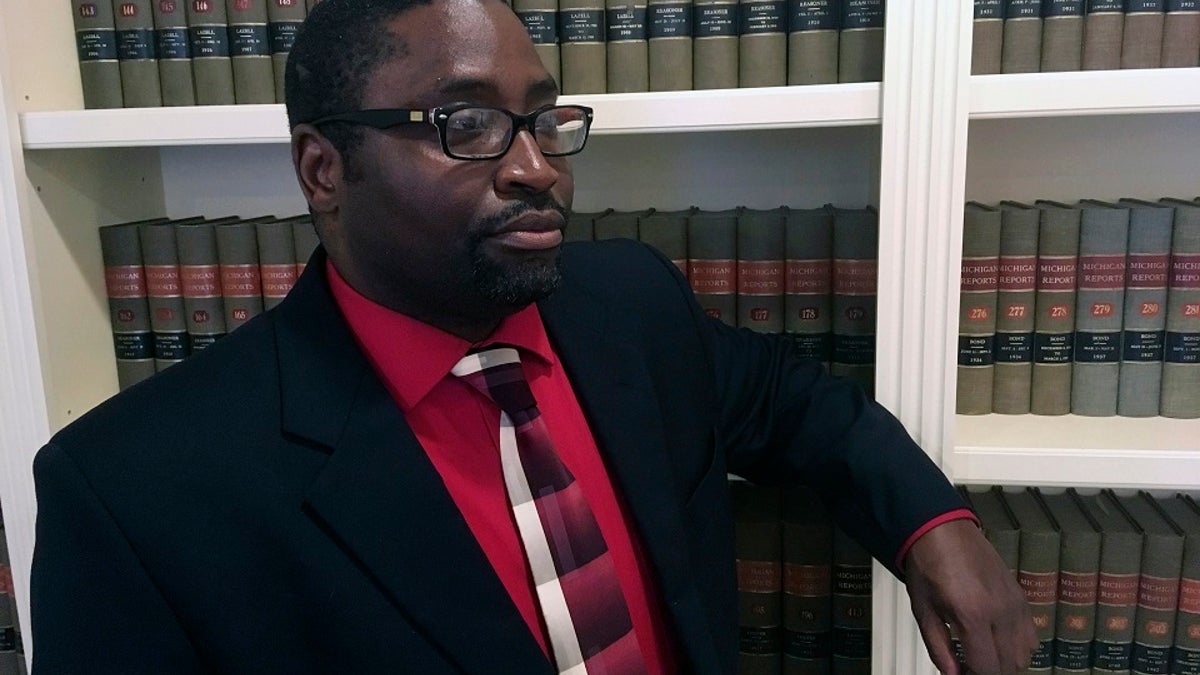 Sauntore Thomas poses in his attorney's office on Thursday in Bloomfield Hills, Mich. Thomas, a black Air Force veteran who tried to deposit settlement checks from a discrimination lawsuit was rejected by his suburban Detroit bank, which suspected fraud and called police. (AP Photo/Mike Householder)