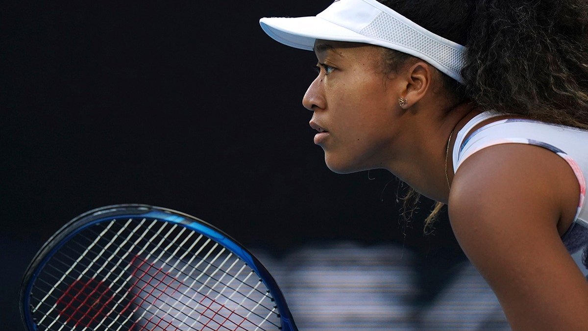 Japan's Naomi Osaka waits to receive serve from Coco Gauff of the U.S. during their third round singles match at the Australian Open tennis championship in Melbourne, Australia, Friday, Jan. 24, 2020. (AP Photo/Lee Jin-man)