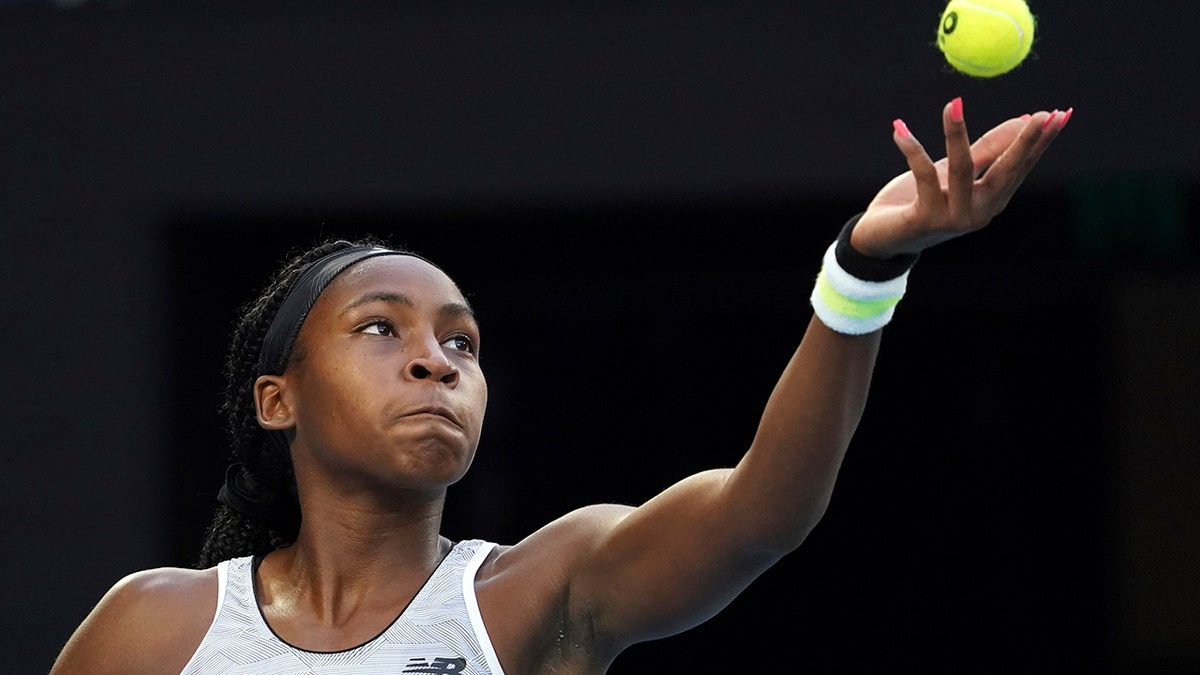 Coco Gauff of the U.S. serves to Japan's Naomi Osaka during their third round singles match at the Australian Open tennis championship in Melbourne, Australia, Friday, Jan. 24, 2020. (AP Photo/Lee Jin-man)