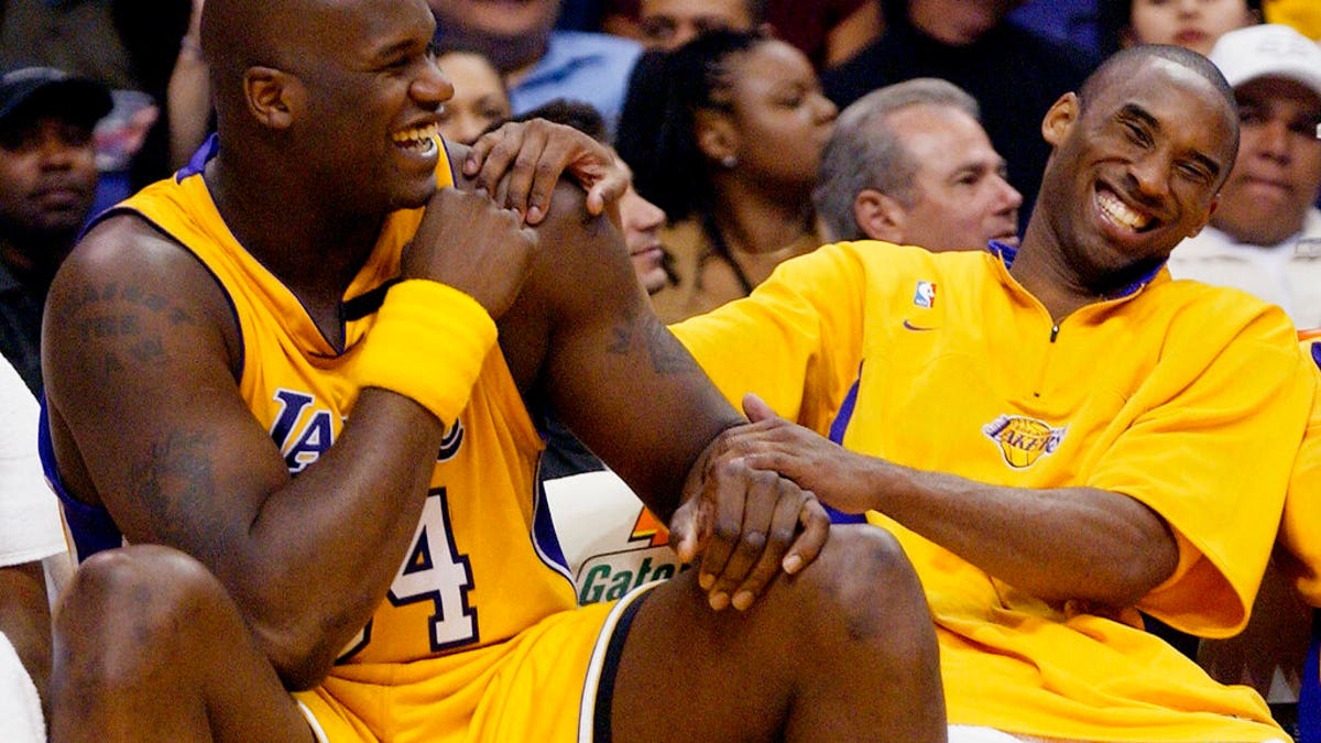 FILE - In this April 15, 2003, file photo, Los Angeles Lakers Shaquille O'Neal, left, and Kobe Bryant share a laugh on the bench while their teammate take on the Denver Nuggets during the fourth quarter at Staples Center in Los Angeles. Bryant, the 18-time NBA All-Star who won five championships and became one of the greatest basketball players of his generation during a 20-year career with the Los Angeles Lakers, died in a helicopter crash Sunday, Jan. 26, 2020. (AP Photo/Kevork Djansezian, File)