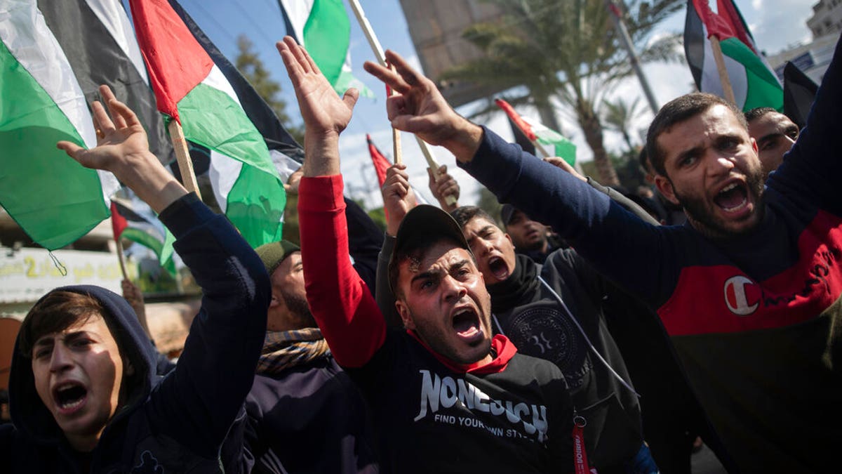 Palestinian protesters chant angry slogans during a protest against the U.S. Mideast peace plan, in Gaza City, Monday, Jan. 28, 2020. 