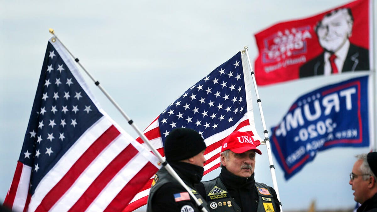 President Donald Trump supporters John Walker, left, and Mike Kufta stand on the Wildwood boardwalk as they wait to attend a campaign rally with Trump, Tuesday, Jan. 28, 2020, in Wildwood, N.J. (AP Photo/Mel Evans)