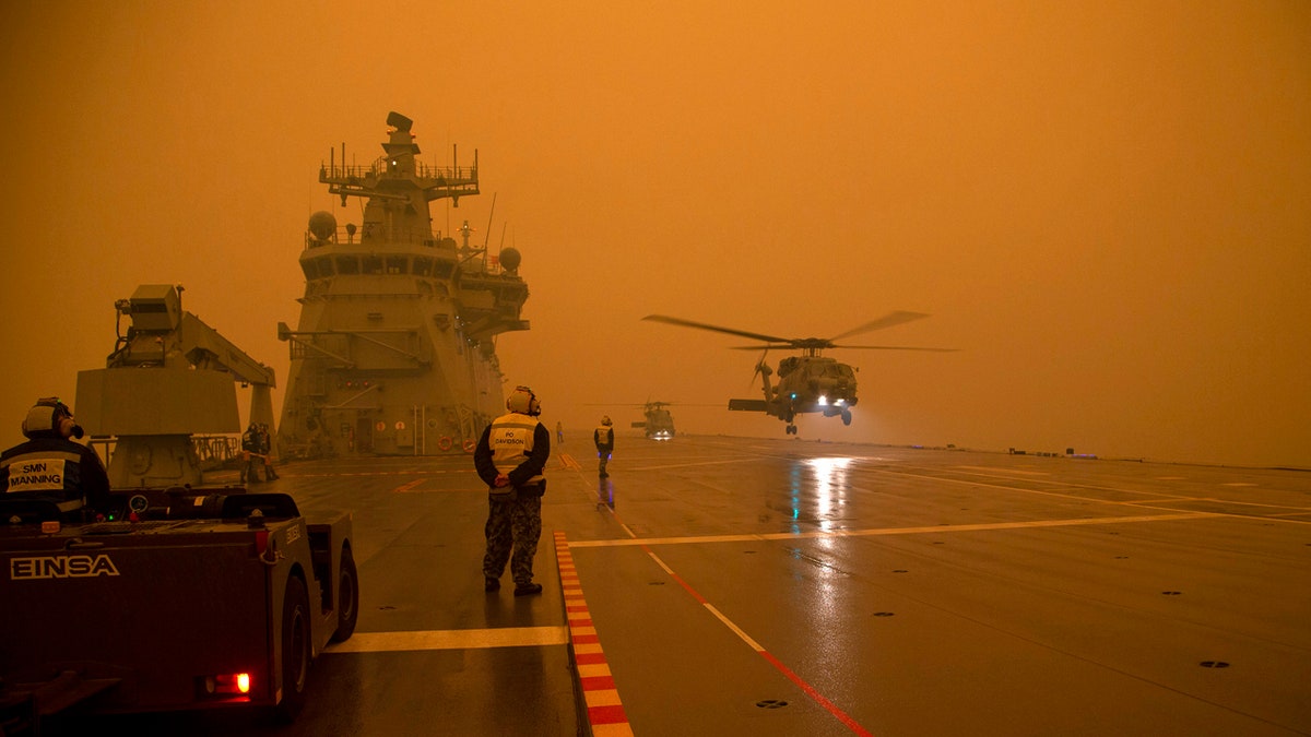 In this photo provided by the Australian Department of Defense, a Royal Australian Navy Seahawk Helicopter departs from HMAS Adelaide while at sea off Australia's east coast, Sunday, Jan. 5, 2020, during operations to assist in battling wildfires.