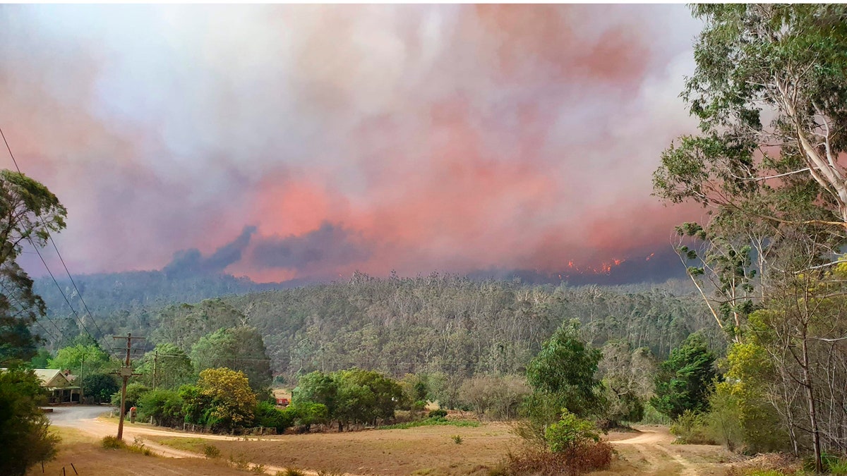 In this Dec. 30, 2019, photo provided by Siobhan Threlfall, a fire approaches the village of Nerrigundah, Australia. The tiny village has been among the hardest hit by Australia's devastating wildfires.