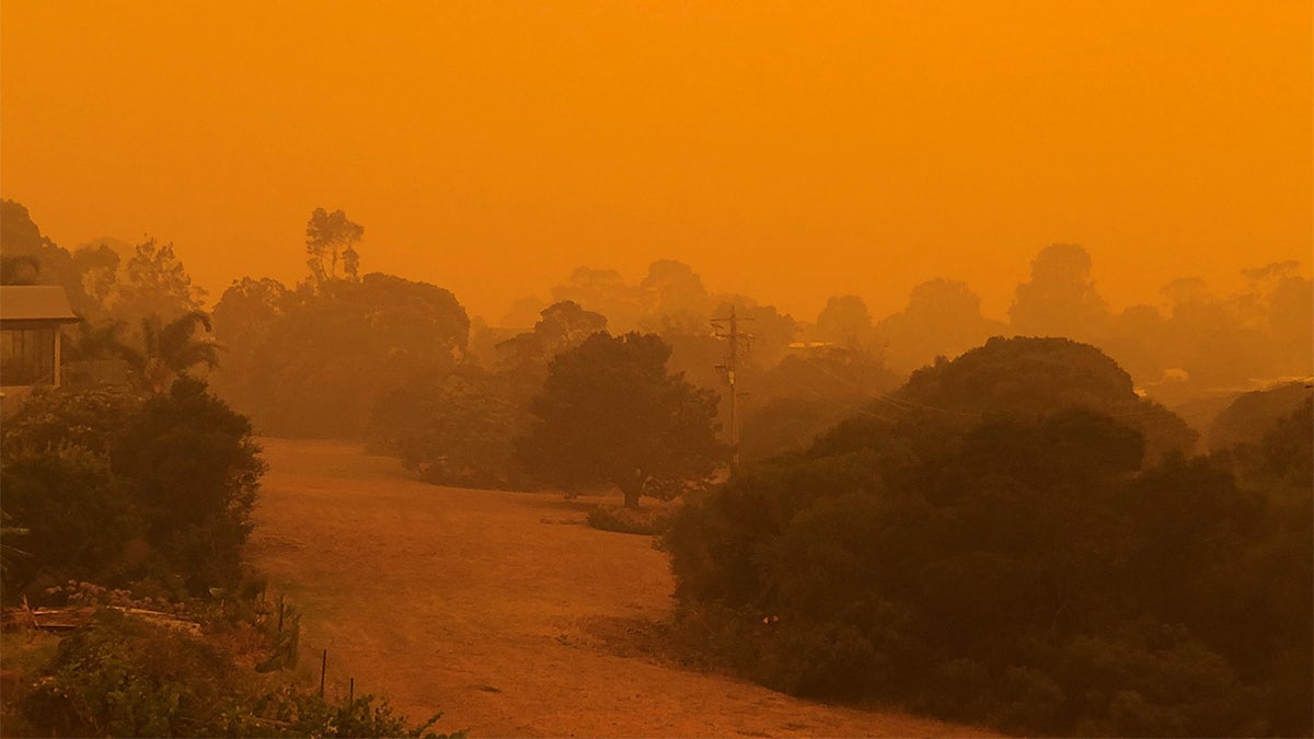 The sky glows orange as surrounding wildfires close in on the town of Mallacoota, Victoria, Australia, January 4, 2020, in this photo obtained from social media. 