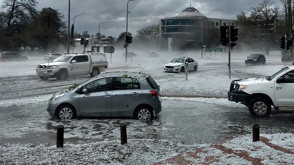 Hail covers vehicles in an intersection Monday, Jan. 20, 2020, in Canberra, Australia.