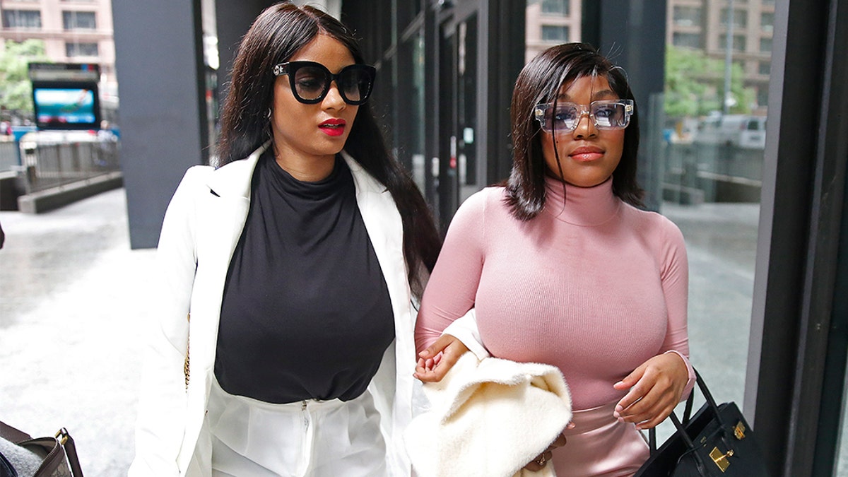Supporters of singer R. Kelly, Azriel Clary and Joycelyn Savage right, leave after the singer's arraignment at the Dirksen Federal Building on July 16, 2019 in Chicago, Illinois. Chicago police said the two women got into a fight in the embattled singer's Chicago condominium Wednesday. (Photo by Nuccio DiNuzzo/Getty Images)