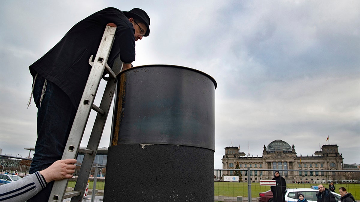 Several activists have tried to dismantle the controversial steel column in Berlin. (Paul Zinken/dpa via AP)