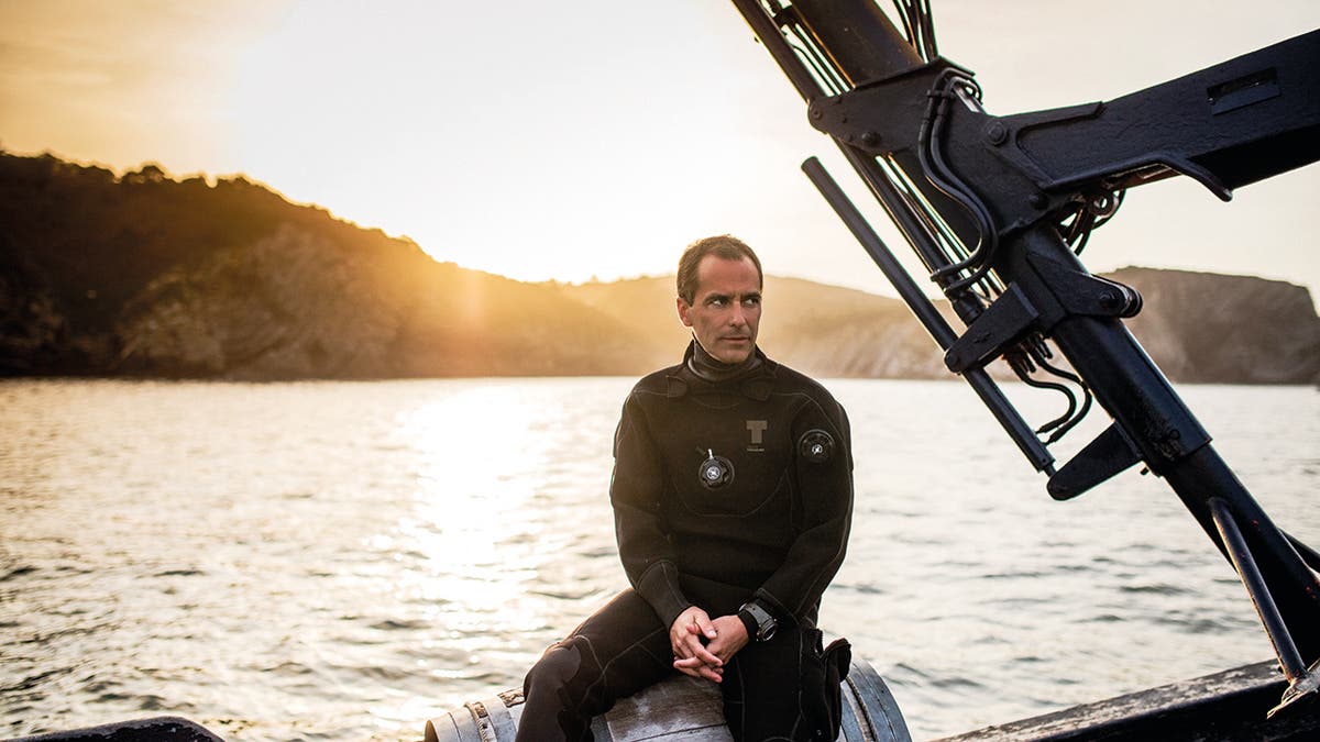 Borja Saracho, the owner of Crusoe Treasure, sits in his boat Capitania Maritima.