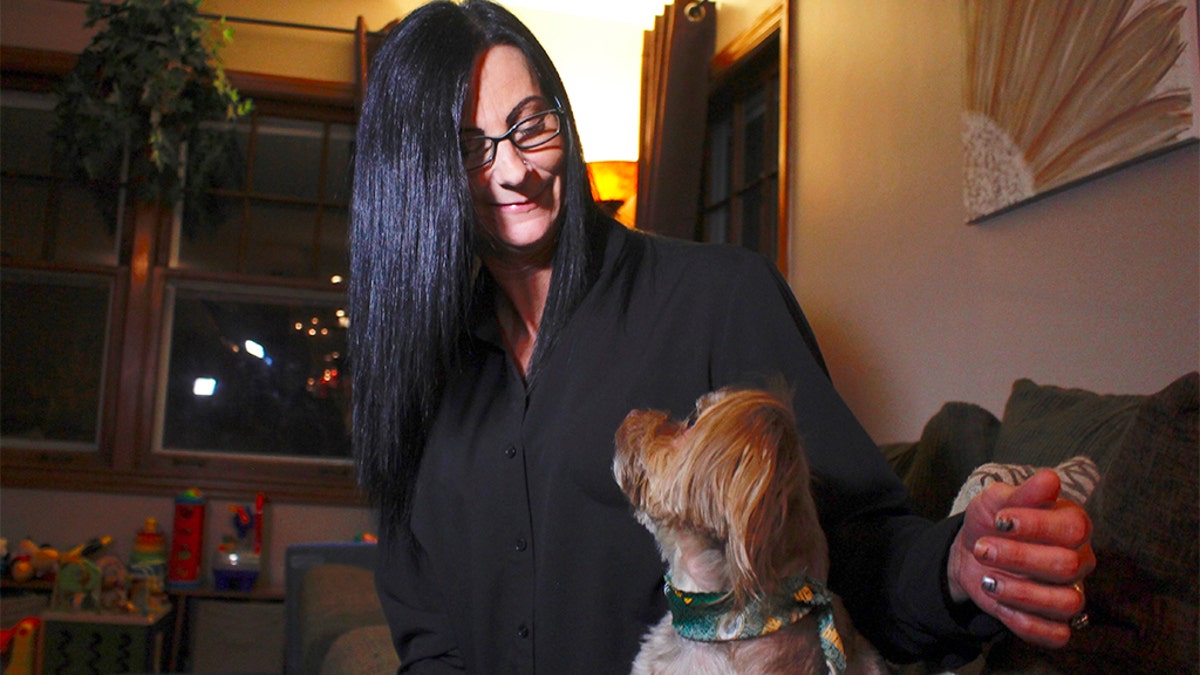 Carter gives her dog CBD, which she says has reduced his epilepsy-related seizures. (AP Photo/Carrie Antlfinger)