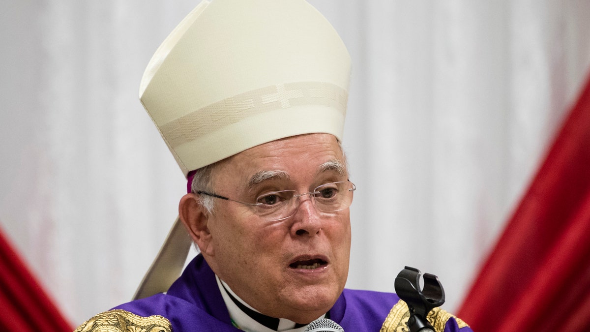 FILE - In this Dec. 18, 2017, file photo, Philadelphia Archbishop Charles Chaput celebrates Mass with inmates at the Curran-Fromhold Correctional Facility in Philadelphia. The Vatican announced Thursday, Jan. 23, 2020, Chaput, who will step down after turning 75 last year, the traditional retirement age for Catholic bishops, will be replaced by bishop of Cleveland Nelson Perez. (AP Photo/Matt Rourke, File)