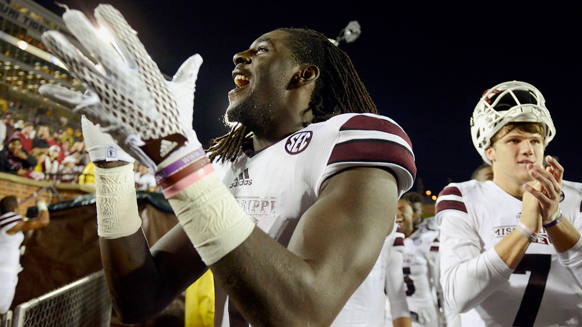 Mississippi State wide receiver De'Runnya Wilson, left, and quarterback Nick Fitzgerald, right, celebrate with the rest of their team after defeating Missouri 31-13 in an NCAA college football game in Columbia, Mo. in 2015. (AP Photo/L.G Patterson, File)