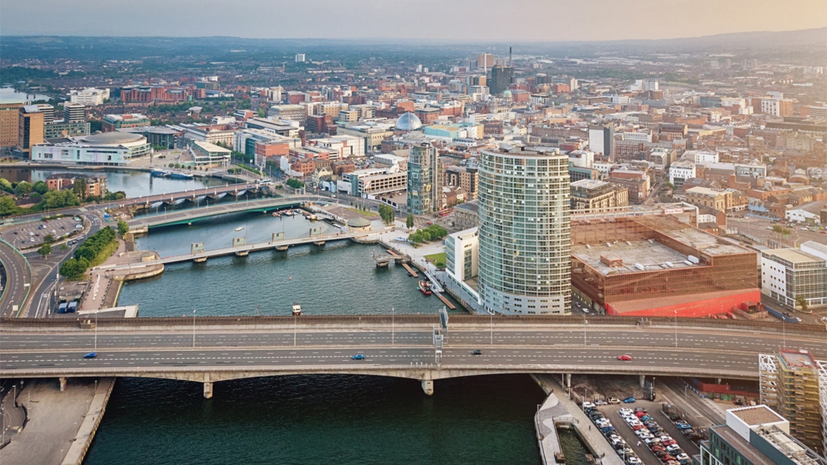 Aerial view over the City of Belfast along the River Lagan with Lagan Bridge in the foreground, ICC Belfast, Lagan Boat and Victoria Square Dome. Belfast, North Ireland, UK