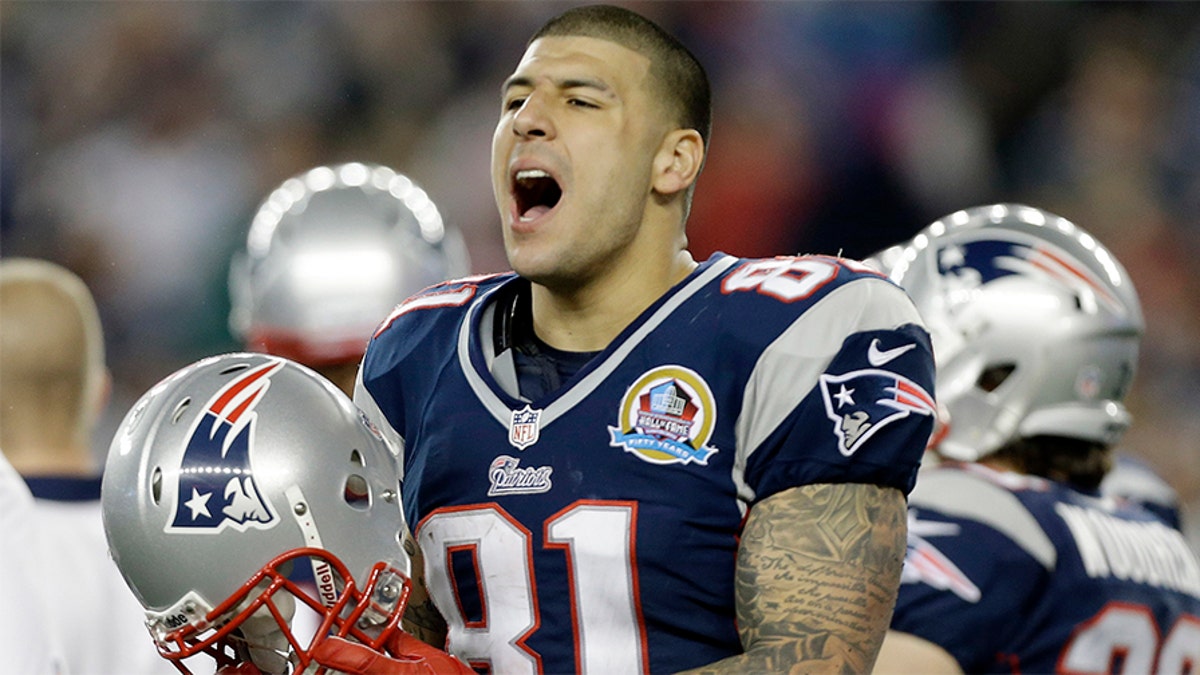 Dec. 10, 2012: New England Patriots tight end Aaron Hernandez reacts during the second quarter of an NFL football game against the Houston Texans in Foxborough, Mass. State and local police spent hours at the home of New England Patriots tight end Aaron Hernandez on Tuesday June 18, 2013 as another group of officers searched an industrial park about a mile away where a body was discovered the day before. (AP Photo/Elise Amendola)