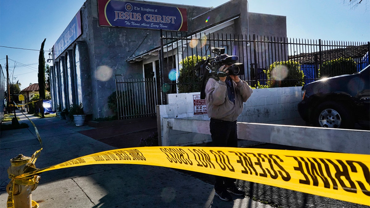 Crime scene tape is seen closing off an area around the grounds of the Kingdom of Jesus Christ Church in the Van Nuys section of Los Angeles on Wednesday. (AP Photo/Richard Vogel)