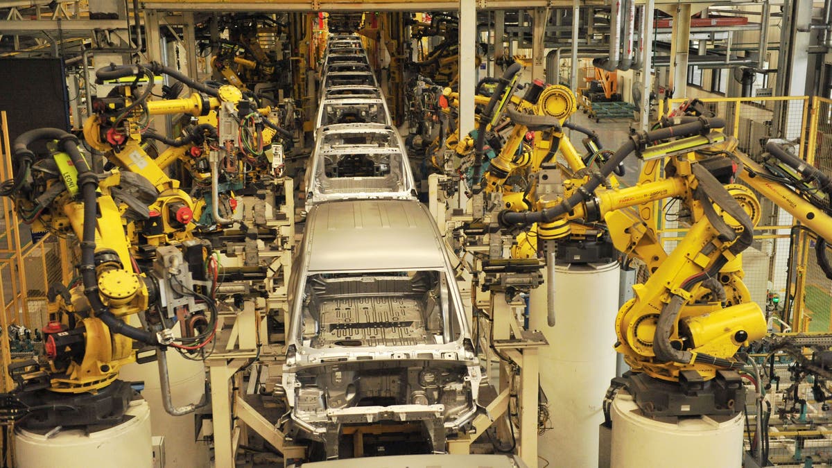 The General Motors ad features a robot from the assembly line. (Photo credit should read YU FANGPING / Barcroft Media via Getty Images)