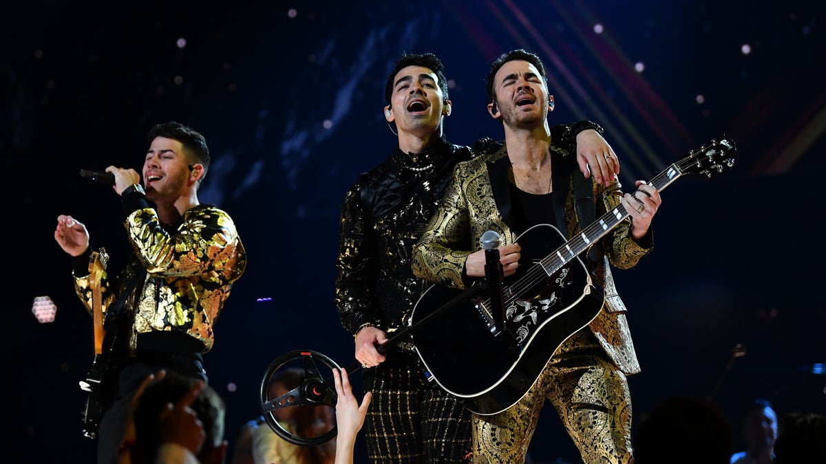 Nick Jonas, Joe Jonas, and Kevin Jonas of music group Jonas Brothers perform onstage during the Grammys.