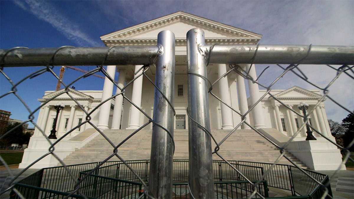 The Virginia state Capitol building is surrounded by fencing, Thursday, Jan. 16, 2020, in Richmond, Va., in preparation for Monday's rally by gun rights advocates. (Dean Hoffmeyer/Richmond Times-Dispatch via AP)