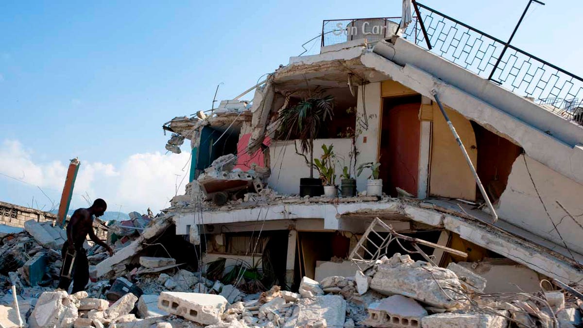 A man searching through the rubble of buildings in the wake of the Jan. 12, 2010 earthquake that devastated Haiti.