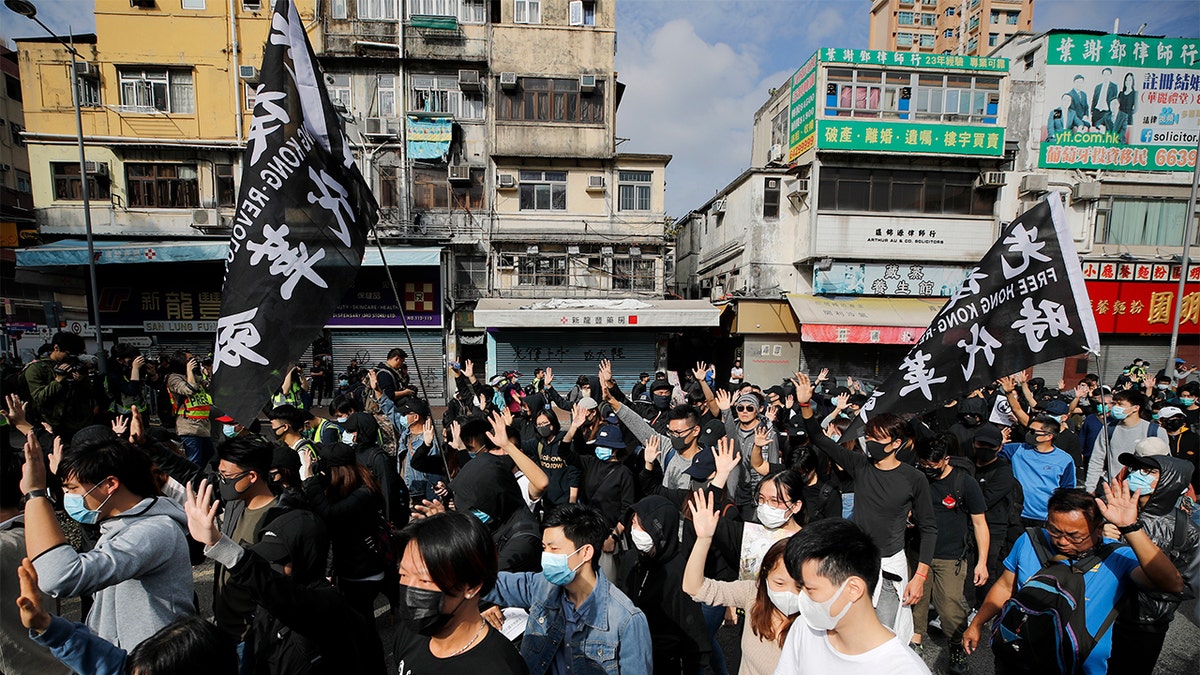 Protesters march Sunday during a demonstration against "parallel traders" who buy goods in Hong Kong to resell in mainland China. (AP Photo/Andy Wong)