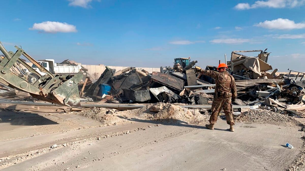 U.S. soldiers clear rubble from a site of Iranian bombing at Ain al-Asad air base in Anbar, Iraq, Monday, Jan. 13, 2020. (AP Photo/Ali Abdul Hassan)