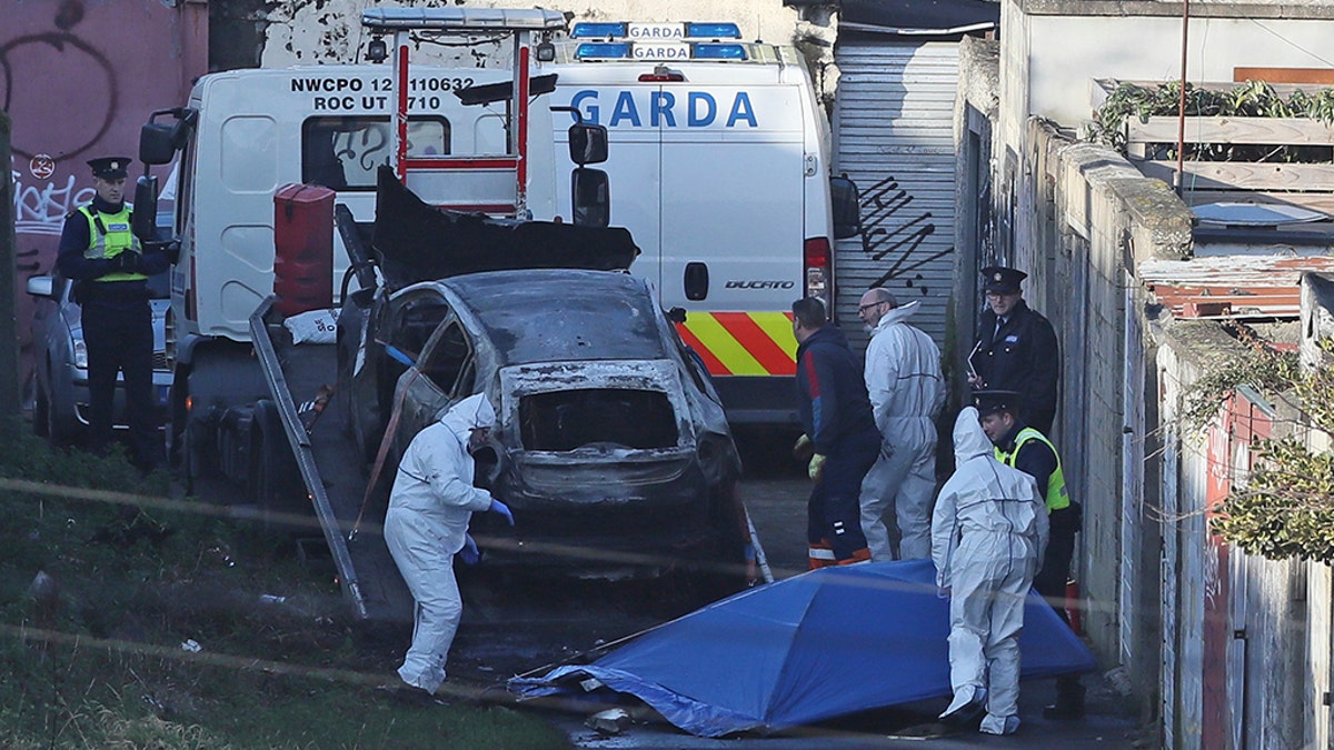  A burnt out car which contained human remains, believed to be linked to the disappearance of a 17-year-old boy from Co Louth, is removed from the scene on Trinity Terrace in the Drumcondra area of Dublin.  (Press Association via AP Images)