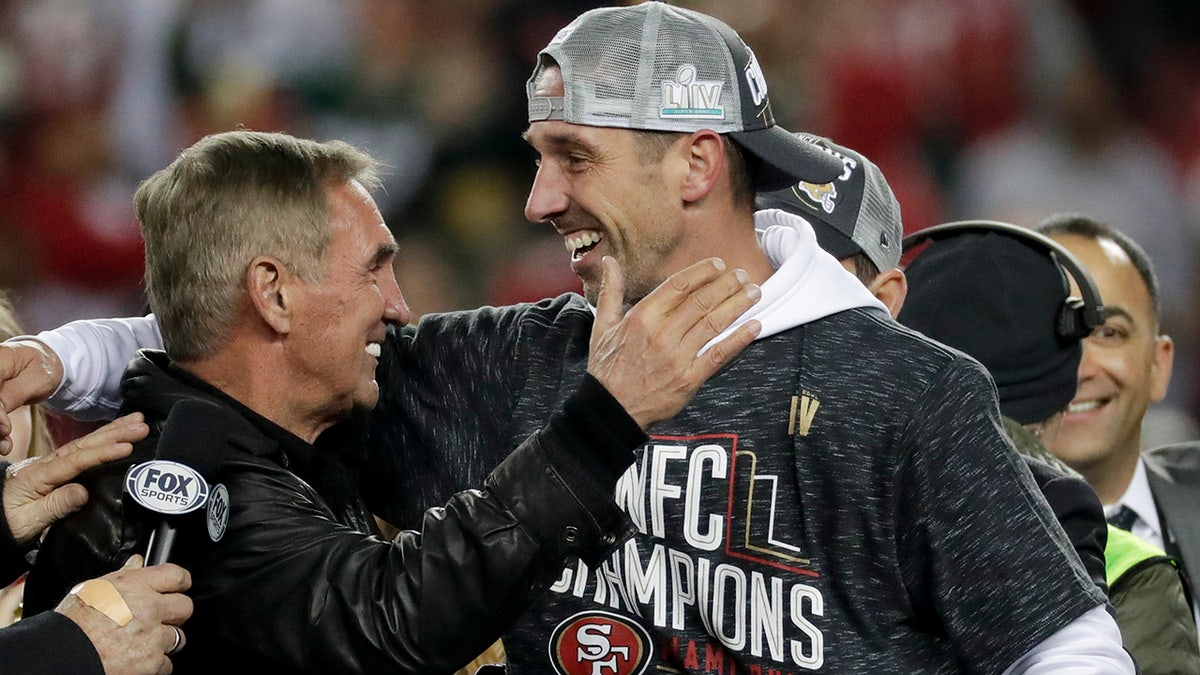 Kyle Shanahan celebrates with his father, Mike, after winning the NFC Championship. (AP Photo/Matt York)