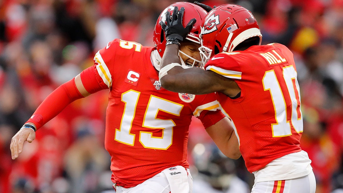 Kansas City Chiefs quarterback Patrick Mahomes (15) celebrating with wide receiver Tyreek Hill during the first half of their playoff game against the Houston Texans. (AP Photo/Jeff Roberson)
