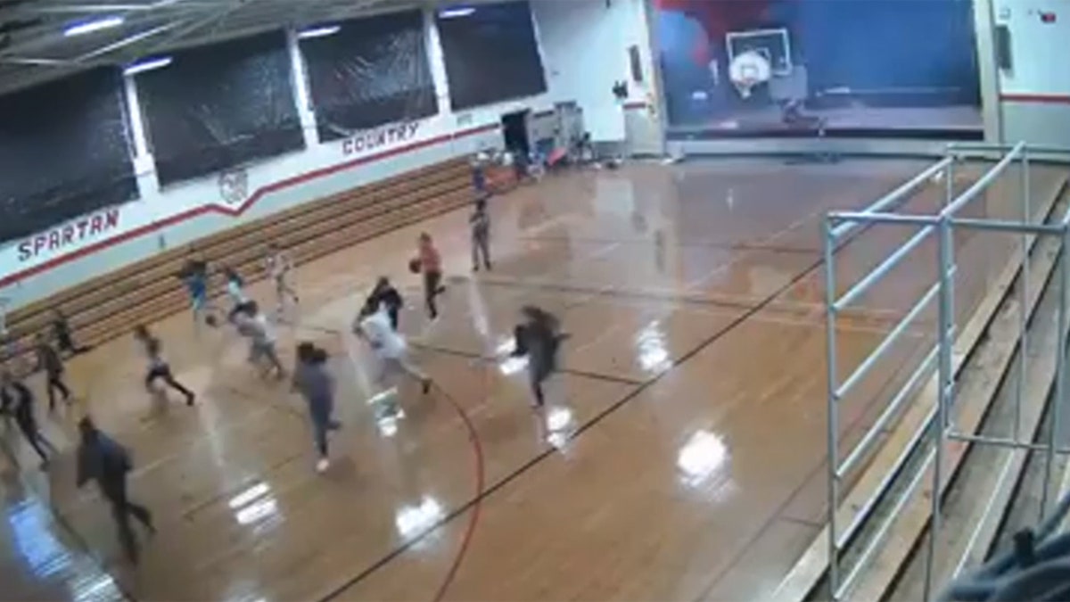 Students can be seen running as the roof begins to fall in when a microburst hit the area.