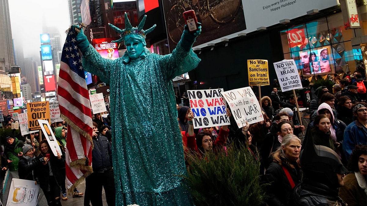 People marched as they take part in an anti-war protest at Times Square. (REUTERS/Eduardo Munoz)