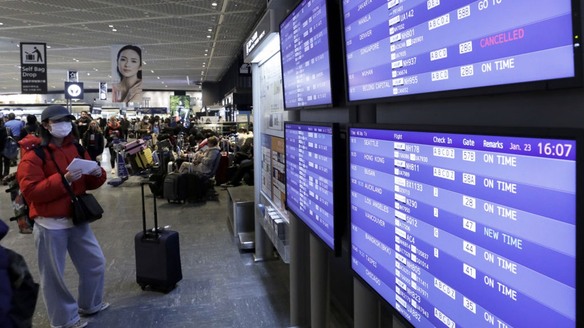 Across the globe — and as seen here on a departures board at the Narita airport in Japan — flights to certain regions of China have been canceled amid reports concerning the novel coronavirus first identified in Wuhan.