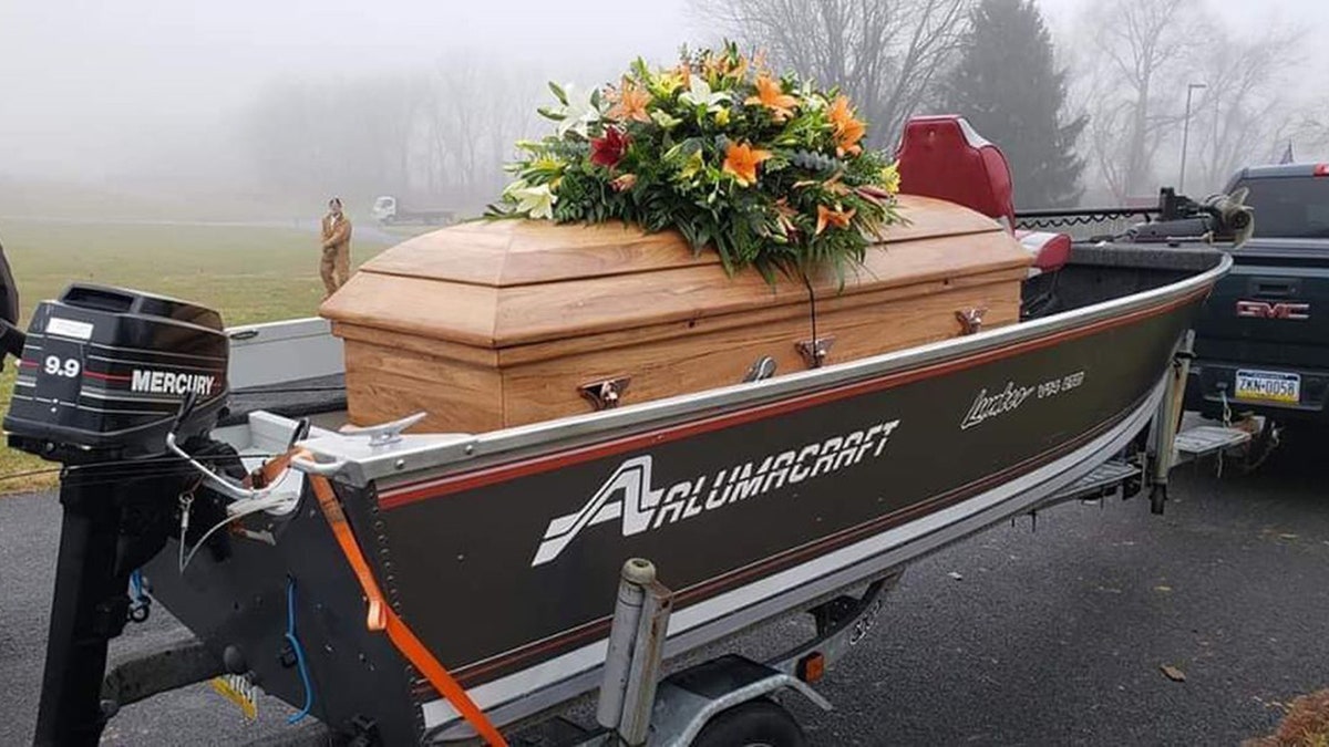 Frey’s brother Jeremy placed a wooden platform inside his fishing boat and transported the casket from the church to the cemetery.
