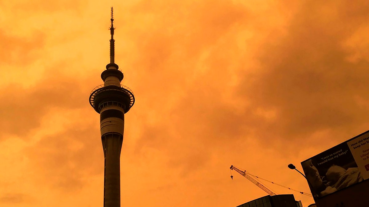 The sky above Auckland's Sky Tower turns orange as smoke from the Australia wildfires arrives in New Zealand, Sunday, Jan. 5, 2020.