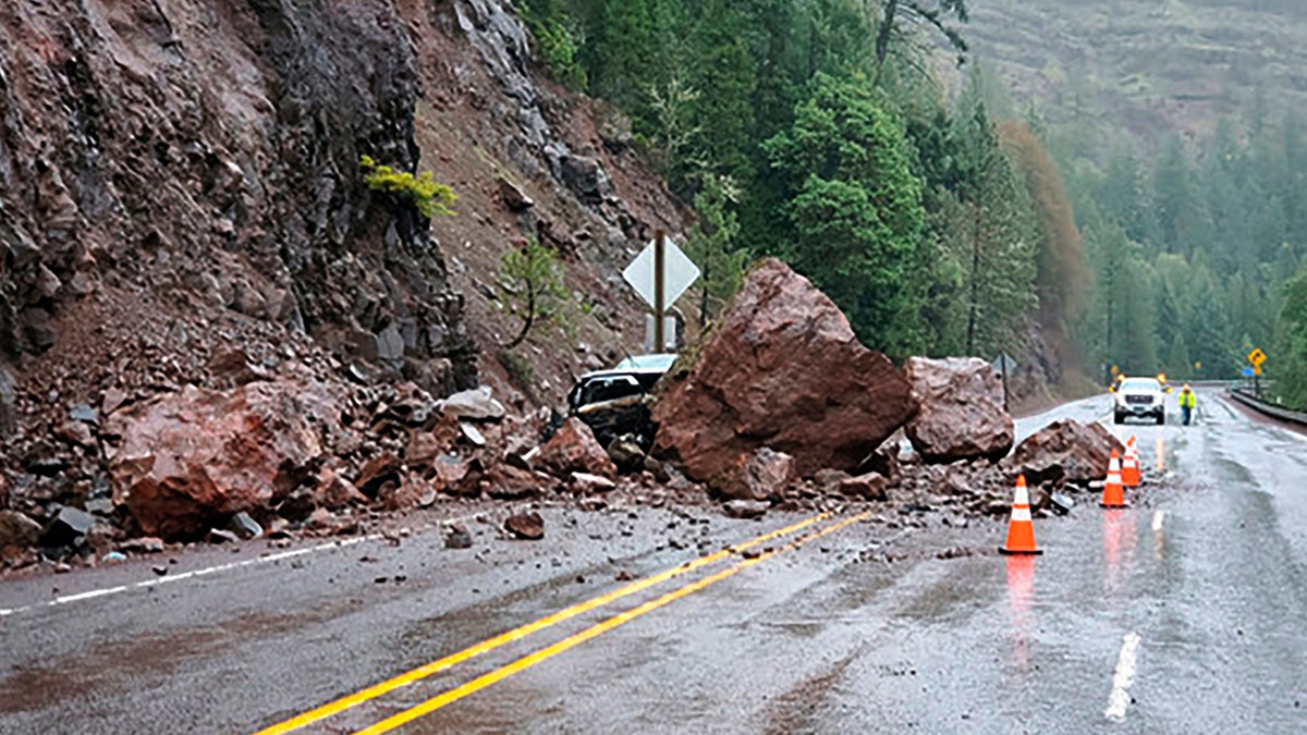 Rockslides triggered by unrelenting rain have closed local roads and highways around Oregon, including a highway near Crater Lake National Park that was closed for hours Tuesday after two boulders the size of a small living room crashed down, narrowly missing the passing car.