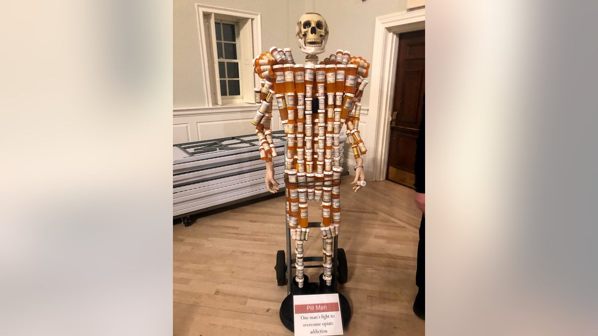 Skelton covered in pill bottles