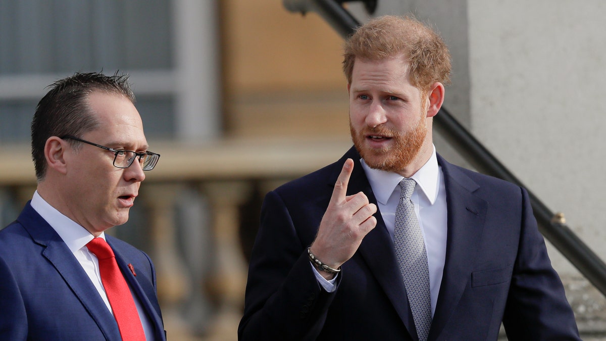 Prince Harry gestures in the gardens at Buckingham Palace in London, Thursday, Jan. 16 ahead of hosting the Rugby League World Cup 2021 draw.