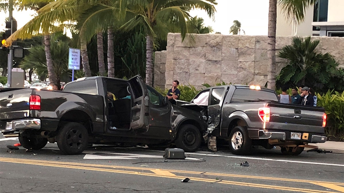 FILE - This Monday, Jan. 28, 2019 file photo shows the scene of a multiple vehicle accident involving two trucks and a bicyclist in Honolulu. Police say a suspected drunk driver slammed into a crowded Honolulu intersection, killing two pedestrians and a bicyclist and injuring five people including himself. (Cindy Ellen Russell/Honolulu Star-Advertiser via AP)