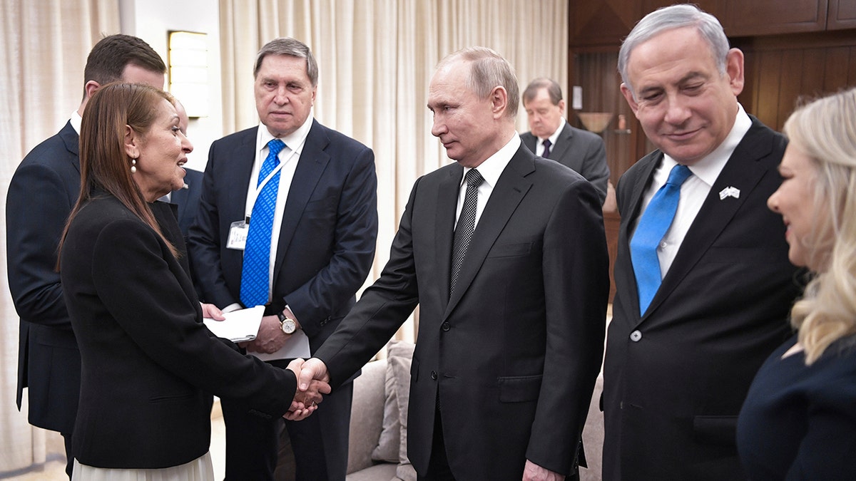 Russian President Vladimir Putin, center, shakes hands with Yaffa Issachar, mother of Israeli citizen Naama Issachar, who is jailed in Russia for drug trafficking, during the meeting with Israeli Prime Minister Benjamin Netanyahu, 2nd right, in Tel-Aviv, Israel, Thursday, Jan. 23, 2020.