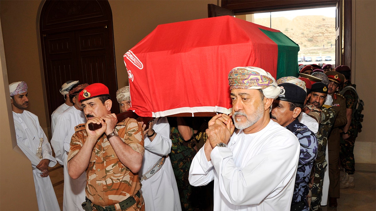 In this photo made available by Oman News Agency, Oman's new sultan Haitham bin Tariq Al Said, right, carries the Sultan Qaboos' coffin at Sultan Qaboos Grand Mosque in Muscat, Oman, Saturday, Jan. 11, 2020. Sultan Qaboos bin Said, the Mideast's longest-ruling monarch who seized power in a 1970 palace coup and pulled his Arabian sultanate into modernity while carefully balancing diplomatic ties between adversaries Iran and the U.S., has died. He was 79. (Oman News Agency via AP)