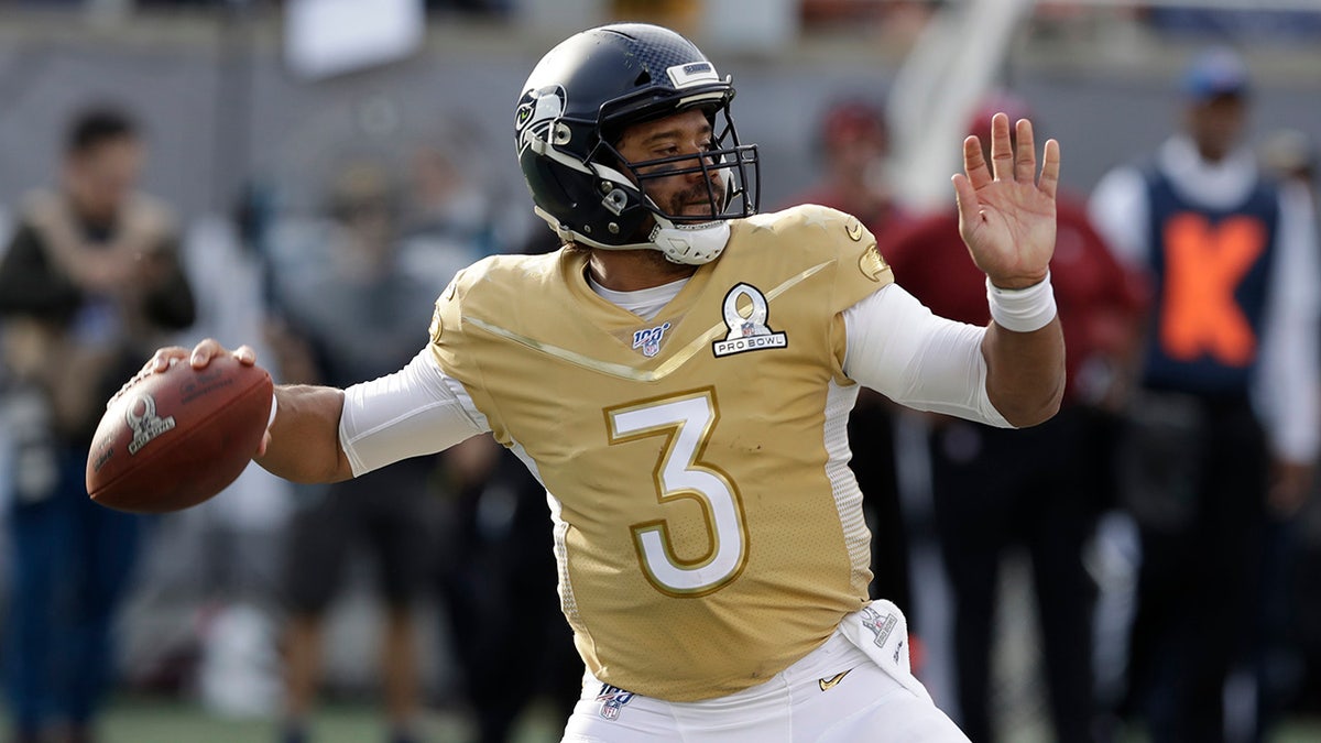 NFC quarterback Russell Wilson, of the Seattle Seahawks, (3) looks to pass, during the first half of the NFL Pro Bowl football game against the AFC, Sunday, Jan. 26, 2020, in Orlando, Fla. (AP Photo/Chris O'Meara)