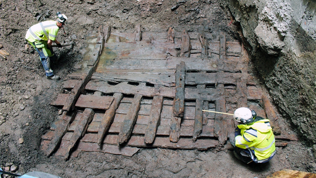 Archaeologists examine the wreck.