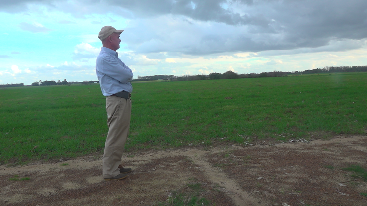 Farmer Murray Campbell stands on his farm, which pumps about 8-10 inches of water per acre in a growing season.