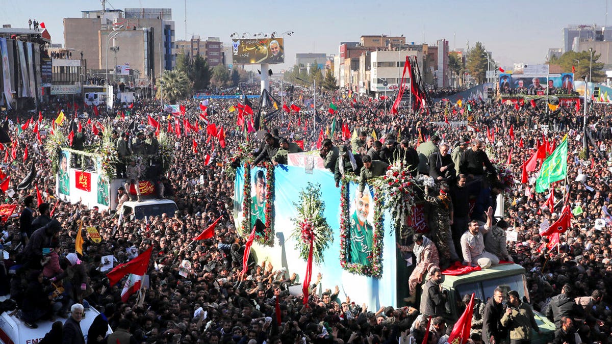 Coffins of Gen. Qassem Soleimani and others who were killed in Iraq by a U.S. drone strike, are carried on a truck surrounded by mourners during a funeral procession, in the city of Kerman, Iran, Tuesday, Jan. 7, 2020. The leader of Iran's Revolutionary Guard threatened on Tuesday to "set ablaze" places supported by the United States over the killing of a top Iranian general in a U.S. airstrike last week, sparking cries from the crowd of supporters of "Death to Israel!" (Erfan Kouchari/Tasnim News Agency via AP)