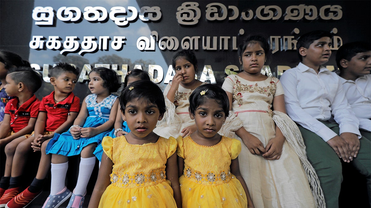 A set of twins stand next to one another in Colombo, Sri Lanka.(REUTERS/Dinuka Liyanawatte)