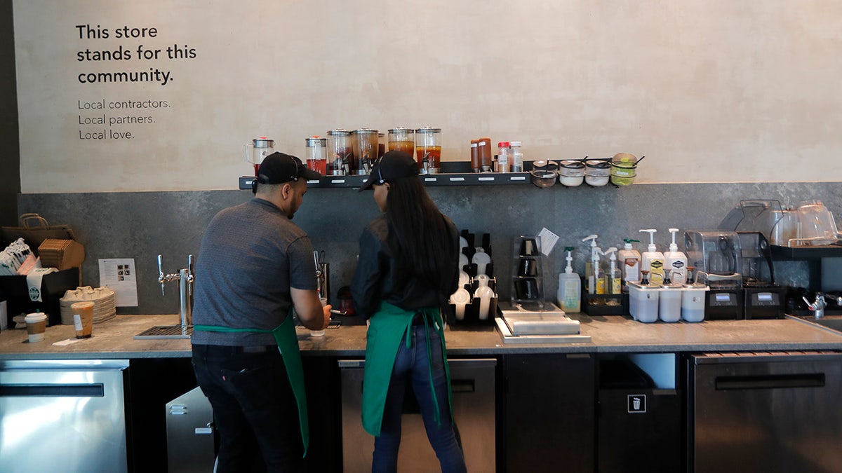 Baristas prepare drinks at a Starbucks on South Claiborne Ave. in New Orleans, Thursday. (AP Photo/Gerald Herbert)