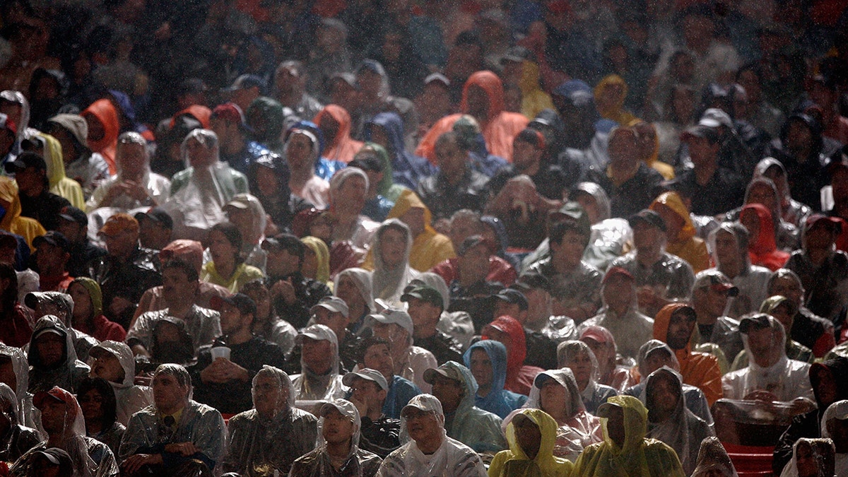 Fans sit in the rain as they watch Super Bowl XLI between the Chicago Bears and the Indianapolis Colts on February 4, 2007 at Dolphin Stadium in Miami Gardens, Florida. The Colts defeated the Bears 29-17.