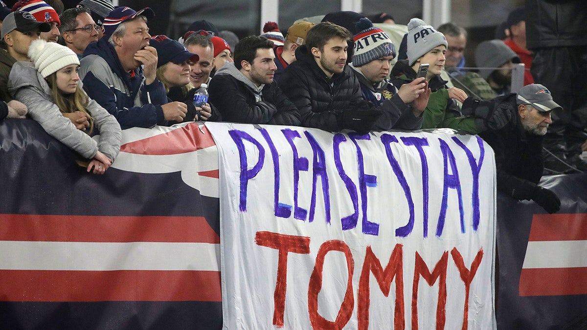 New England Patriots fans stand by a sign supporting quarterback Tom Brady in the first half of an NFL wild-card playoff football game between the Patriots and the Tennessee Titans, Saturday, Jan. 4, 2020, in Foxborough, Mass. Brady's contract expires at the end of the season. (AP Photo/Elise Amendola)