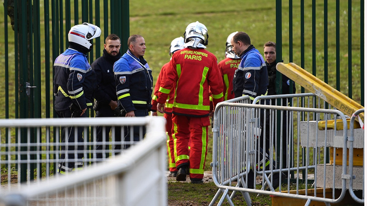 Police and firefighters gather in a park south of Paris on Friday​​​​​​​ where a man was shot and killed by officers after stabbing passers-by. 