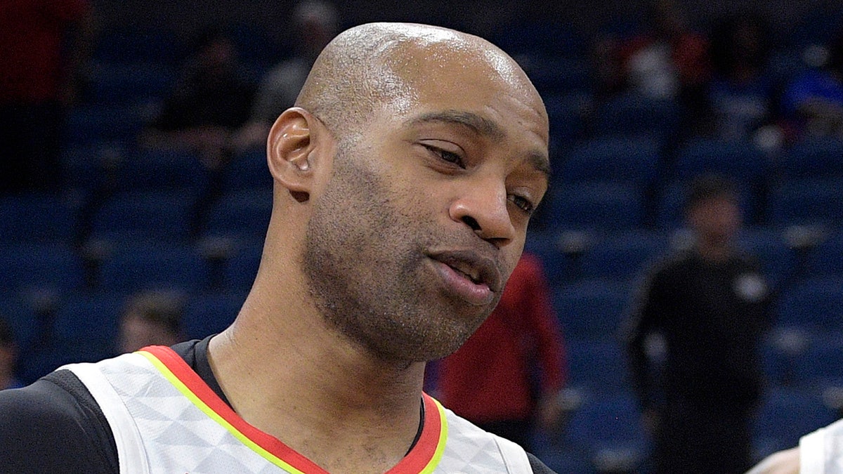 Atlanta Hawks guard Vince Carter (15) congratulates guard Brandon Goodwin (0) after an NBA basketball game against the Orlando Magic, Monday, Dec. 30, 2019, in Orlando, Fla. (AP Photo/Phelan M. Ebenhack)