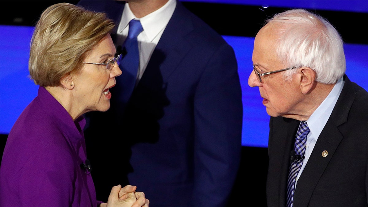 Democratic presidential candidate Sen. Elizabeth Warren, D-Mass., left and Sen. Bernie Sanders, I-Vt., talk Tuesday, Jan. 14, 2020, after a Democratic presidential primary debate hosted by CNN. (AP Photo/Patrick Semansky)